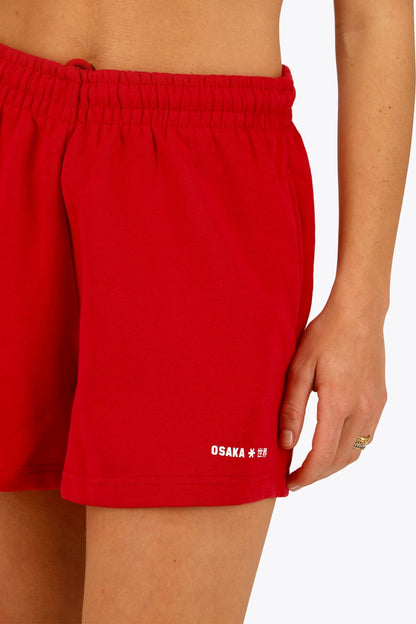 Osaka women shorts in red with logo in white. Front detail logo view