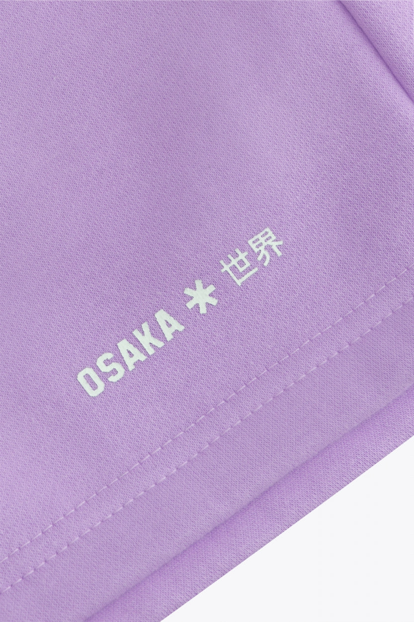 Osaka women shorts in light purple with logo in white. Front flatlay detail logo view