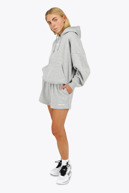 Woman wearing the Osaka women shorts in heather grey with logo in white. Front view