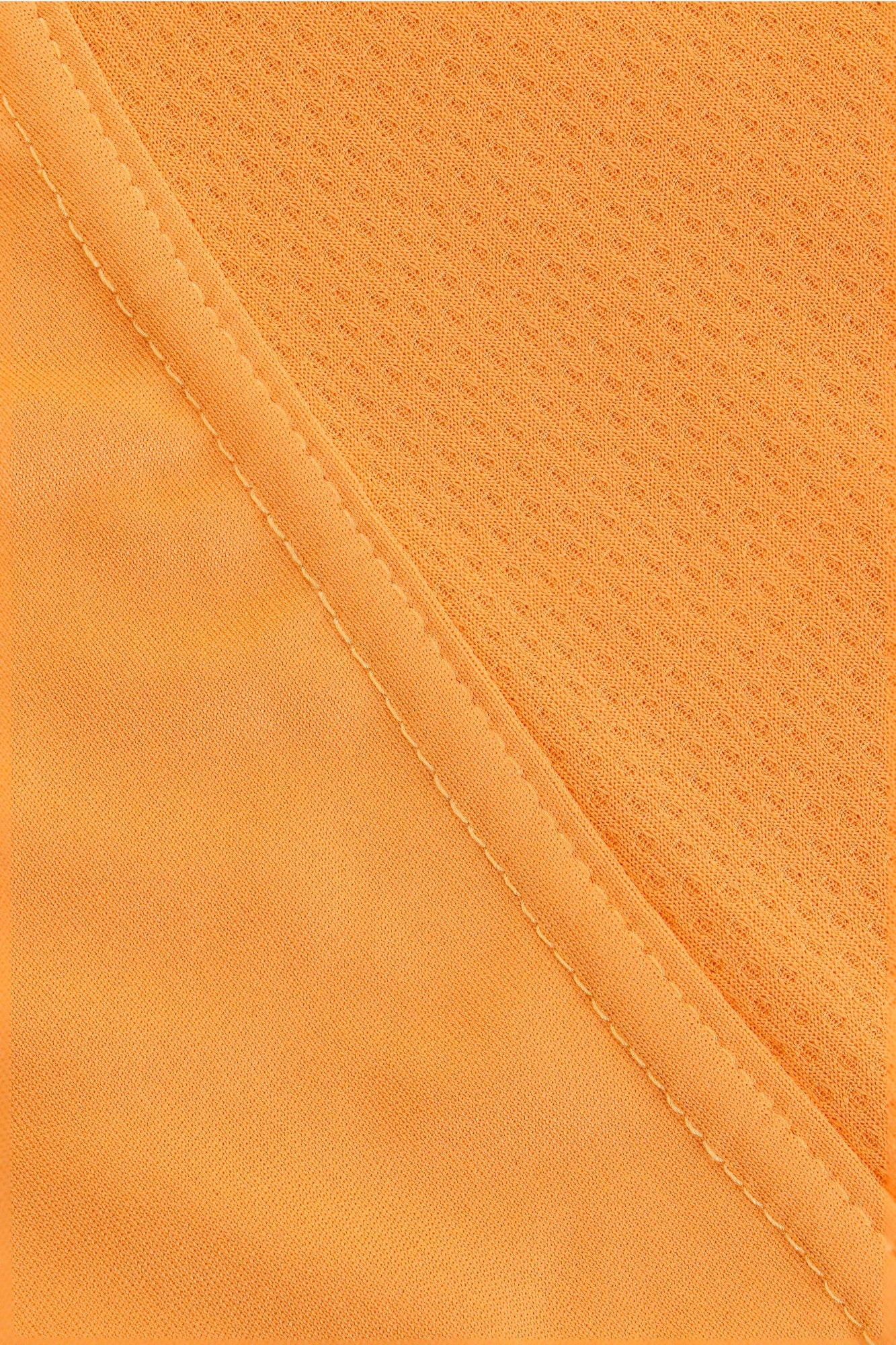 Osaka women singlet in orange with logo in grey. Detail fabric view