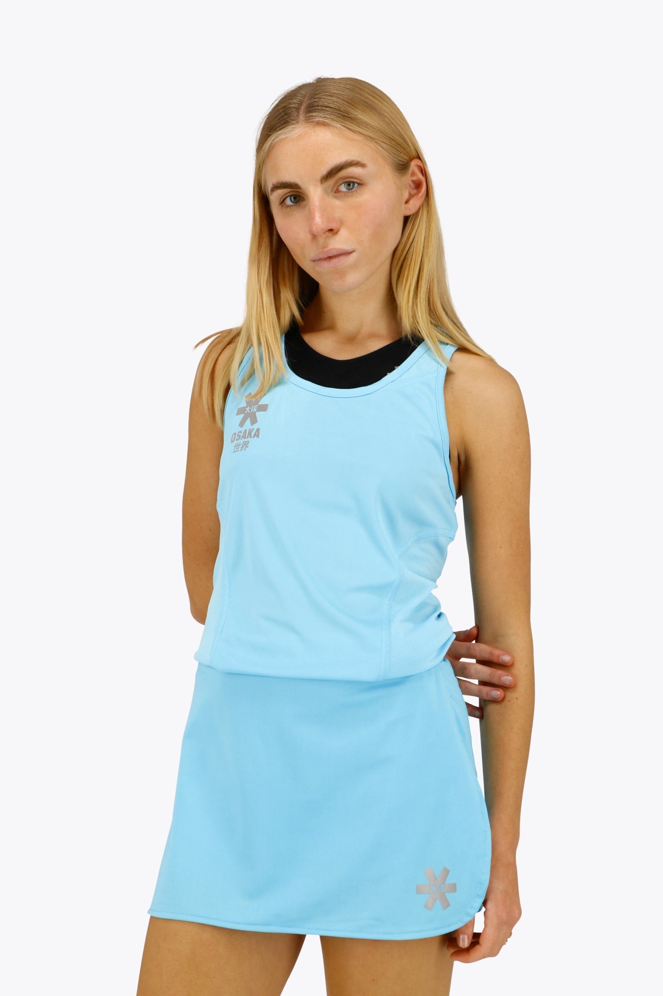Woman wearing the Osaka women singlet in light blue with logo in grey. Front view