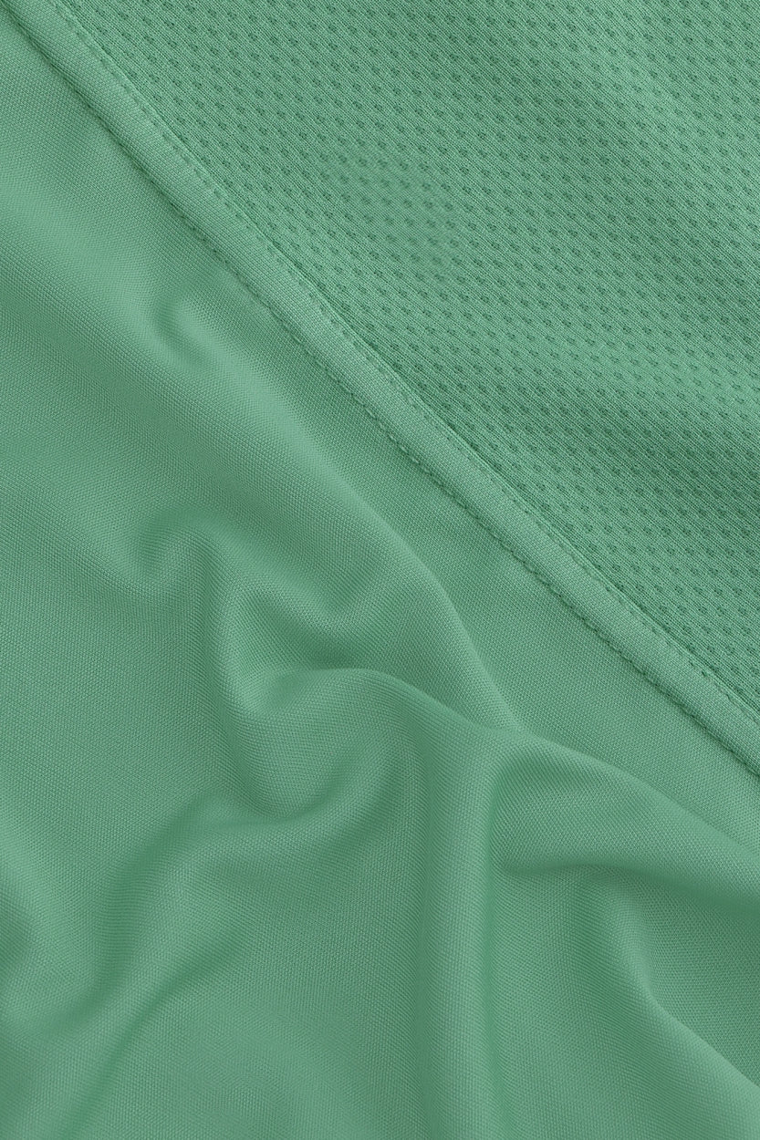 Osaka women singlet in green with logo in grey. detail fabric view