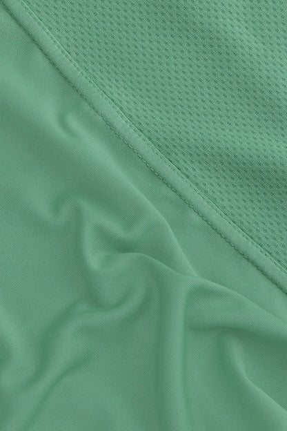 Osaka women singlet in green with logo in grey. detail fabric view
