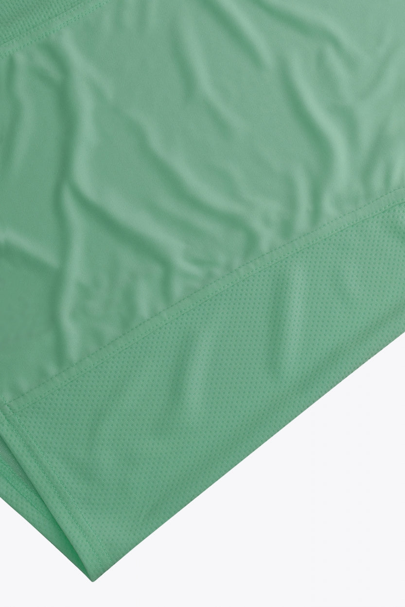 Osaka women singlet in green with logo in grey. Front flatlay detail view