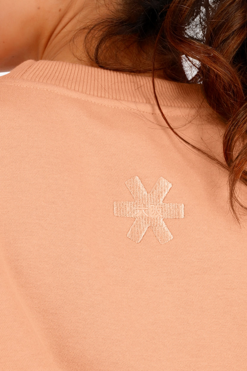 Osaka women sweater in peach with logo in white. Back detail logo view