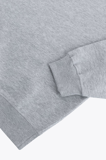 Osaka women sweater in heather grey with logo in white. Front flatlay detail sleeve view