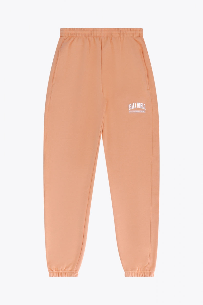 Osaka women sweatpants in peach with logo in white. Front flatlay view