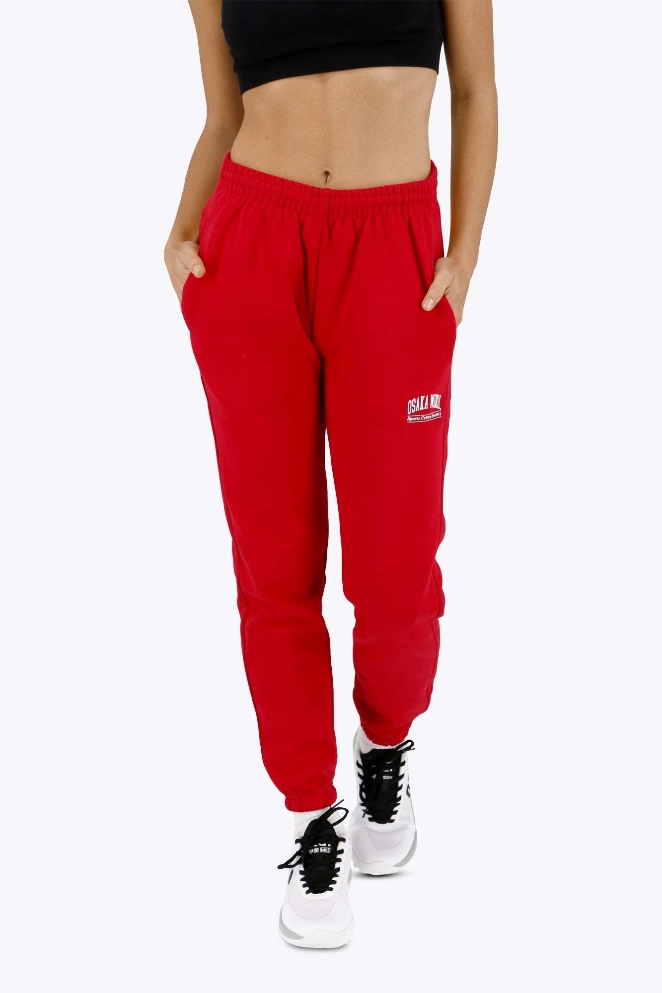 Woman wearing the Osaka women sweatpants in red with logo in white. Front view