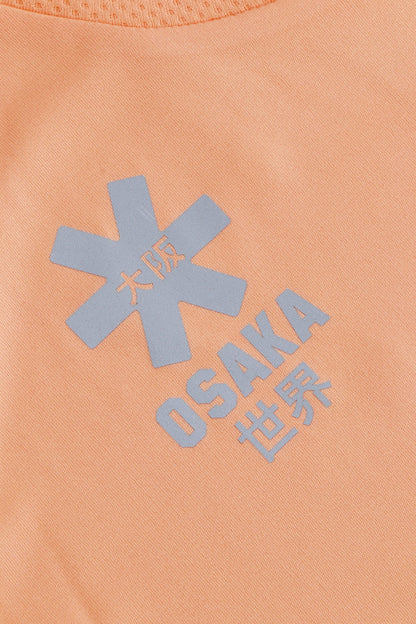 Osaka women tee short sleeve in peach with logo in grey. Detail logo view