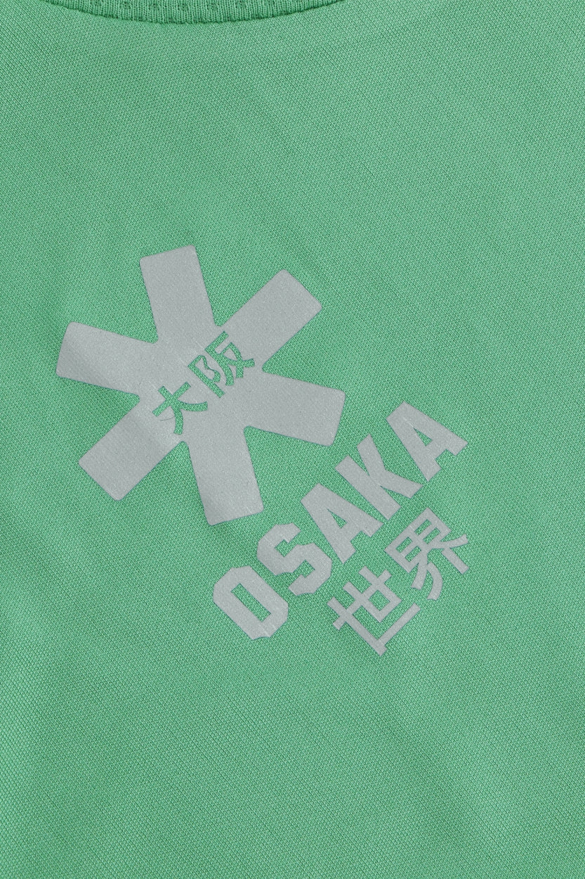 Osaka women tee short sleeve in green with logo in white. Front flatlay detail logo view