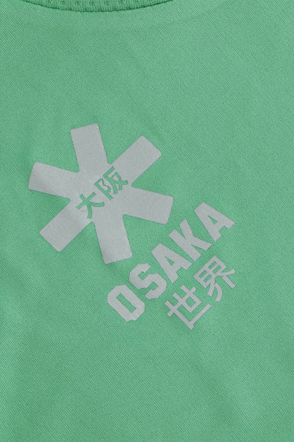 Osaka women tee short sleeve in green with logo in white. Front flatlay detail logo view