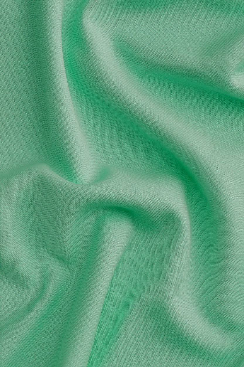 Osaka women tee short sleeve in green with logo in white. Detail fabric view