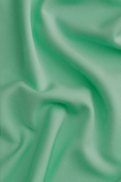 Osaka women tee short sleeve in green with logo in white. Detail fabric view