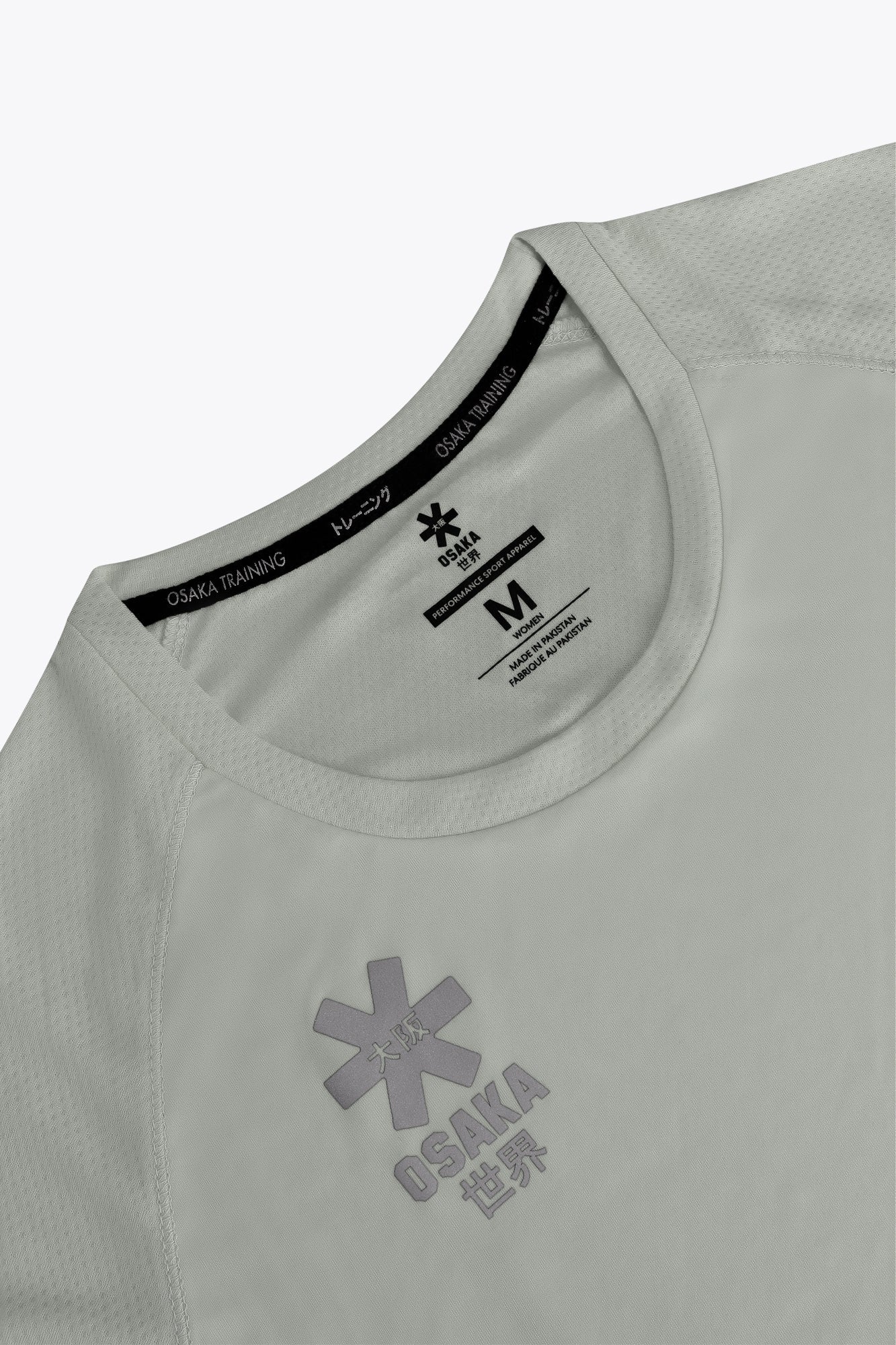Osaka women tee short sleeve in light grey with logo in grey. Front flatlay detail view