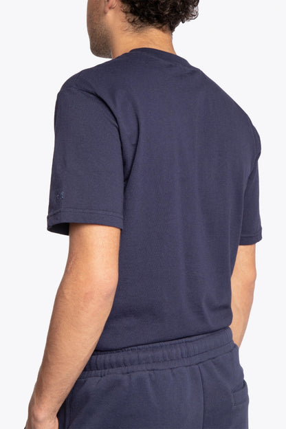 Man wearing the Osaka court classic short in navy with white logo. Back view