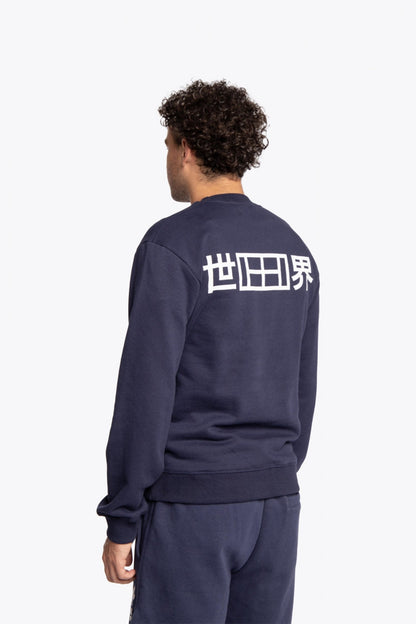 Man wearing the Osaka navy basic unisex sweater with logo in white. Back view
