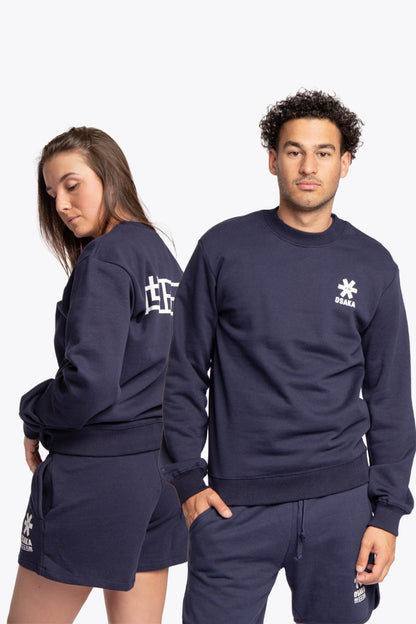 Woman and man wearing the Osaka navy basic unisex sweater with logo in white. Front and back view