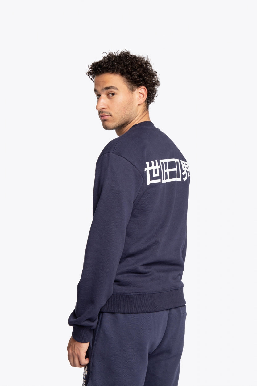 Man wearing the Osaka navy basic unisex sweater with logo in white. Back / side view