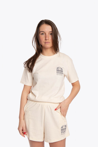 Woman wearing the Osaka unisex tee in cream with logo in grey. Front view