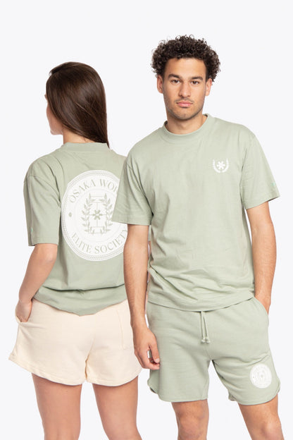 Woman and man wearing the Osaka unisex tee in iceberg green with white logo. Front and back view