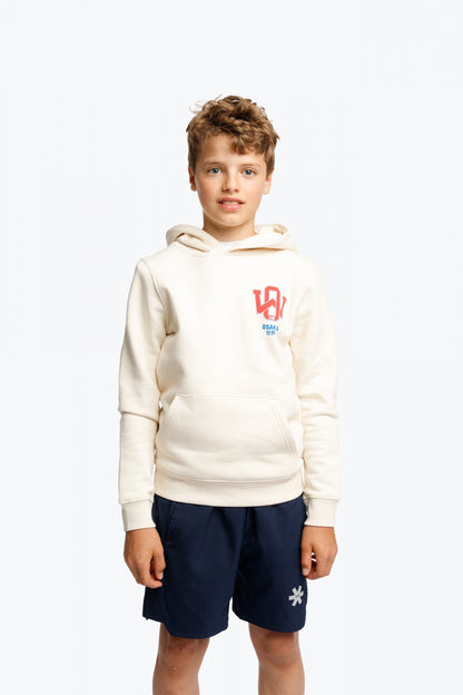 Boy wearing the Osaka kids hoodie in natural raw with college letters in orange and logo in blue. Front view