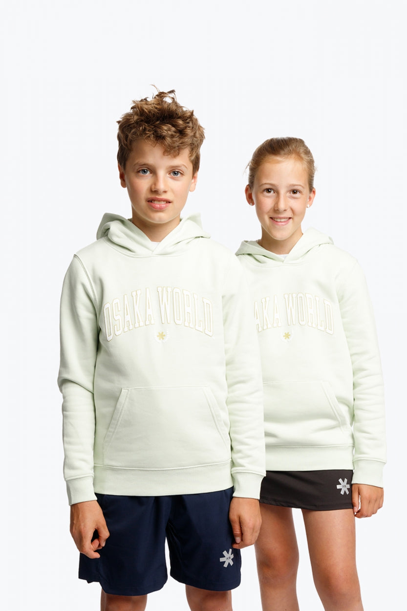Boy and girl wearing the Osaka kids hoodie in mint green with logo in college letters in white. Front view