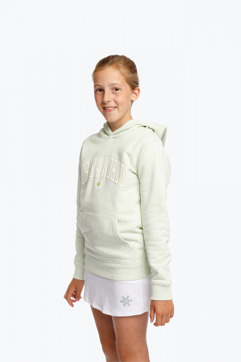 Girl wearing the Osaka kids hoodie in mint green with logo in college letters in white. Front/side view
