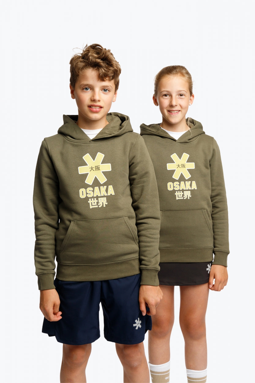 Boy and girl wearing the Osaka kids hoodie in khaki with yellow logo. Front view