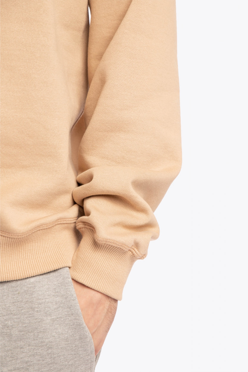 Man wearing the Osaka x Buenas Open sweater in stone. Front detail sleeve view