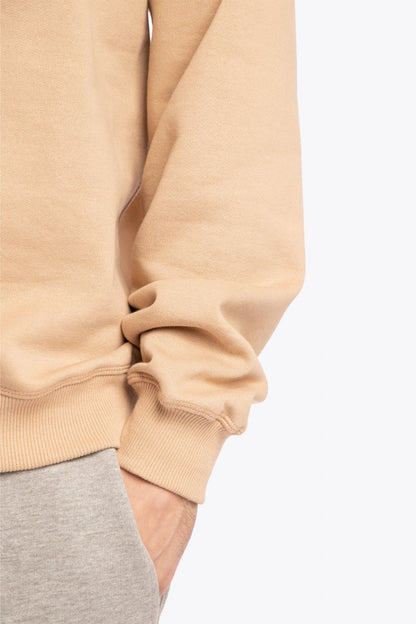 Man wearing the Osaka x Buenas Open sweater in stone. Front detail sleeve view