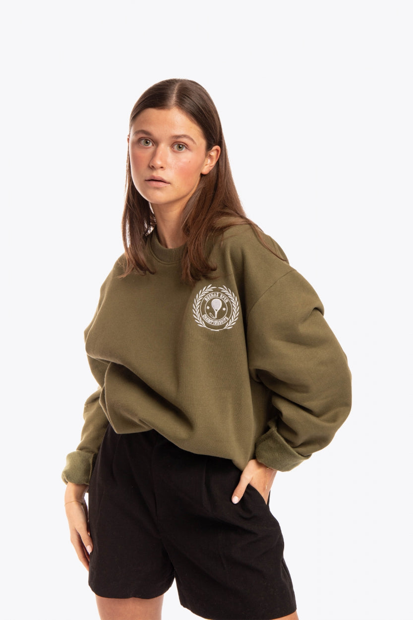 Woman wearing the Osaka x Buenas Open sweater in army green. Front view