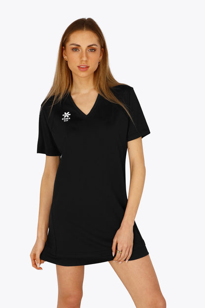 Woman wearing the Osaka women v-neck tech dress in black with logo in grey. Front view