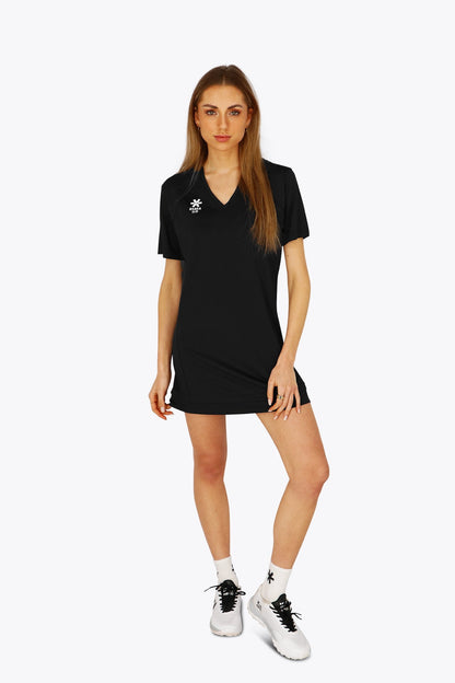 Woman wearing the Osaka women v-neck tech dress in black with logo in grey. Front view