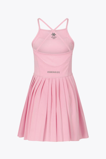 Osaka women pleated tech dress in pink with grey logo. Back flatlay view