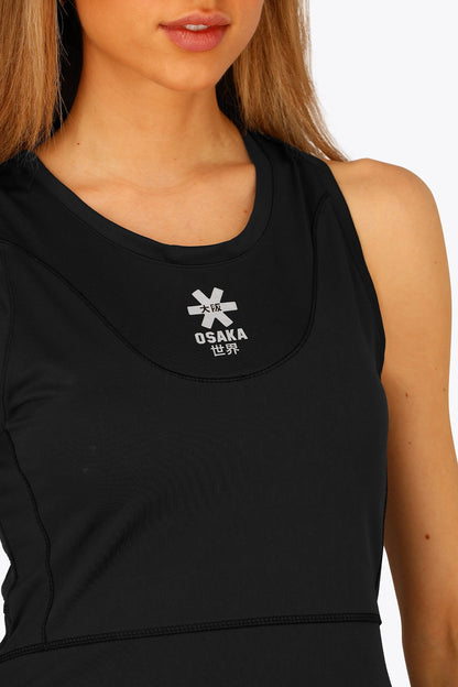 Woman wearing the Osaka women floucy dress black. Front detail logo view