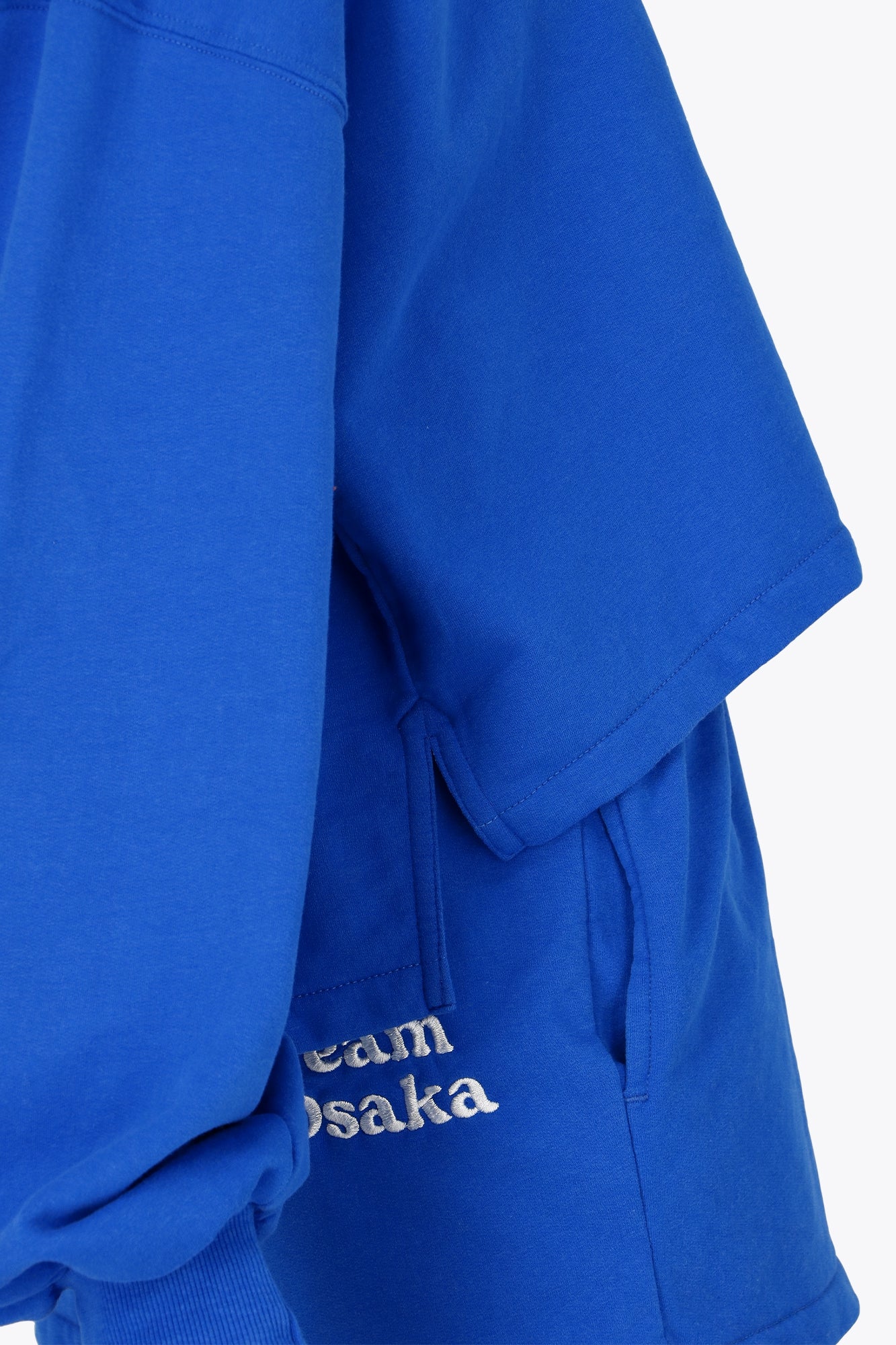 Osaka women cropped hoodie inprincess blue with college logo in white. Side view