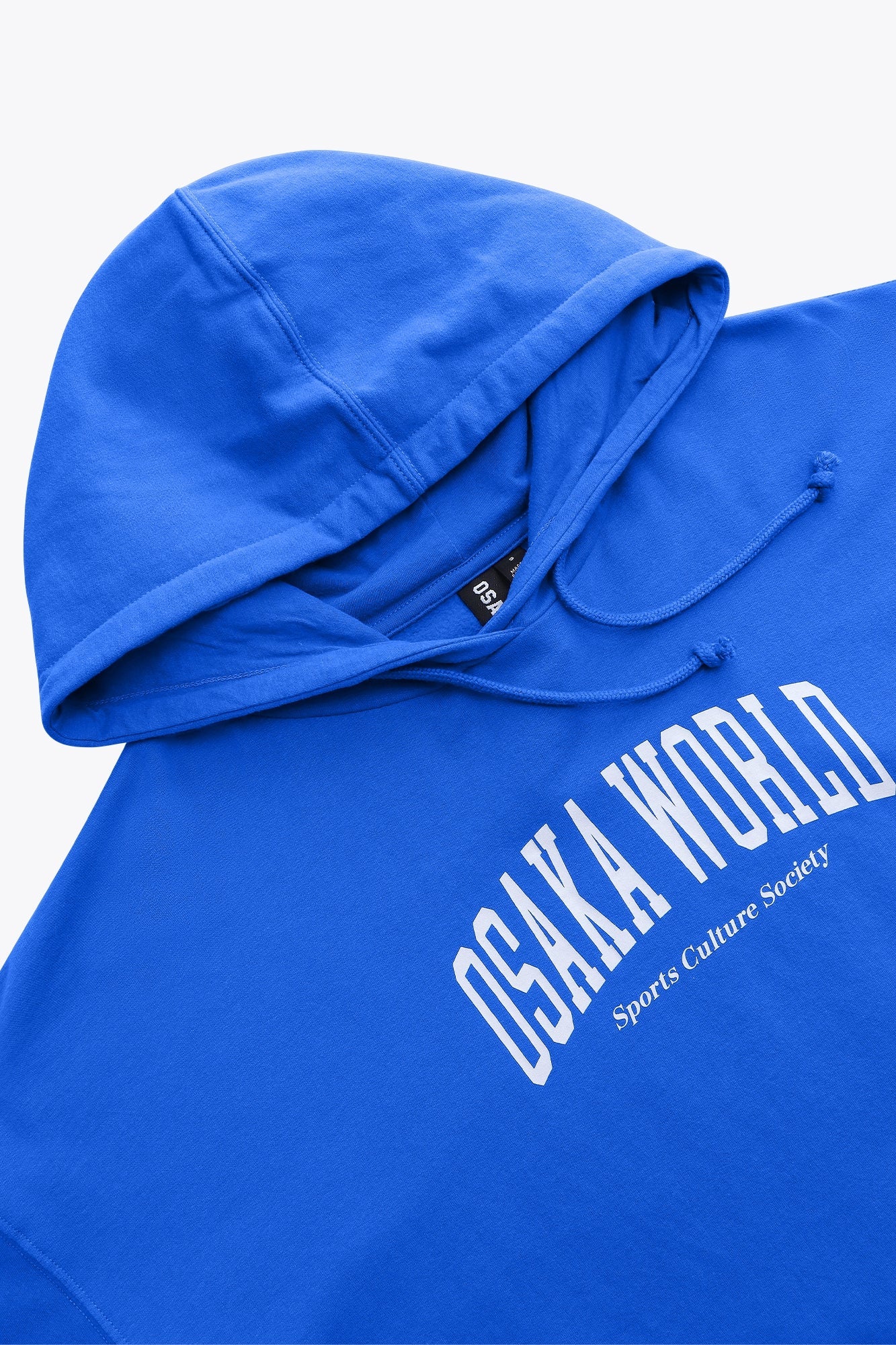 Osaka women cropped hoodie inprincess blue with college logo in white. Front detail neck and cap view