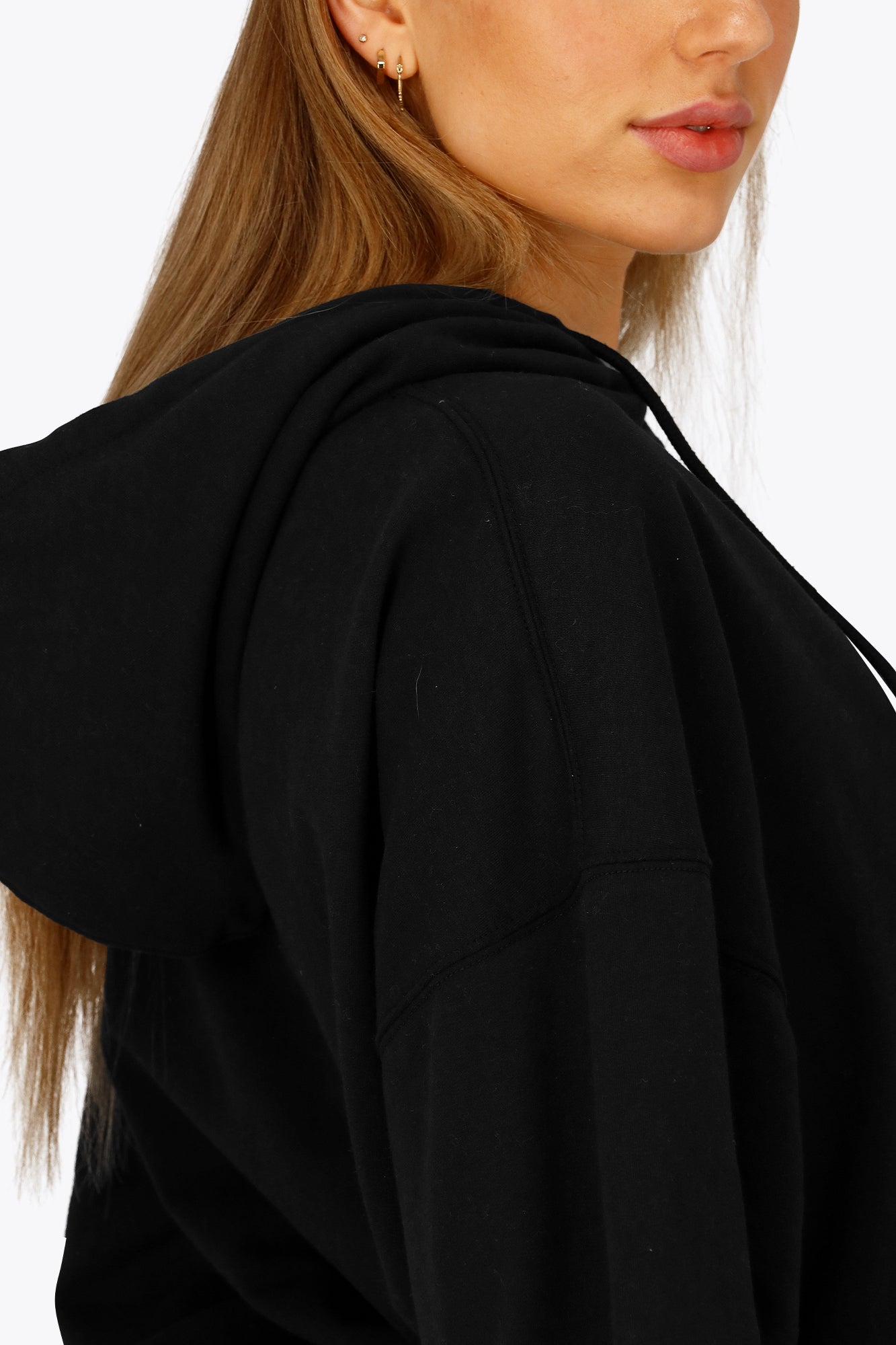 Osaka women cropped hoodie in black with college logo in white. Side view