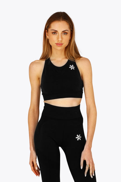 Woman wearing the Osaka women tech sports bra in black with logo in grey. Front view