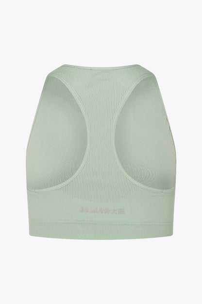 Osaka women tech sports bra in jadeite with logo in grey. Back flatlay view