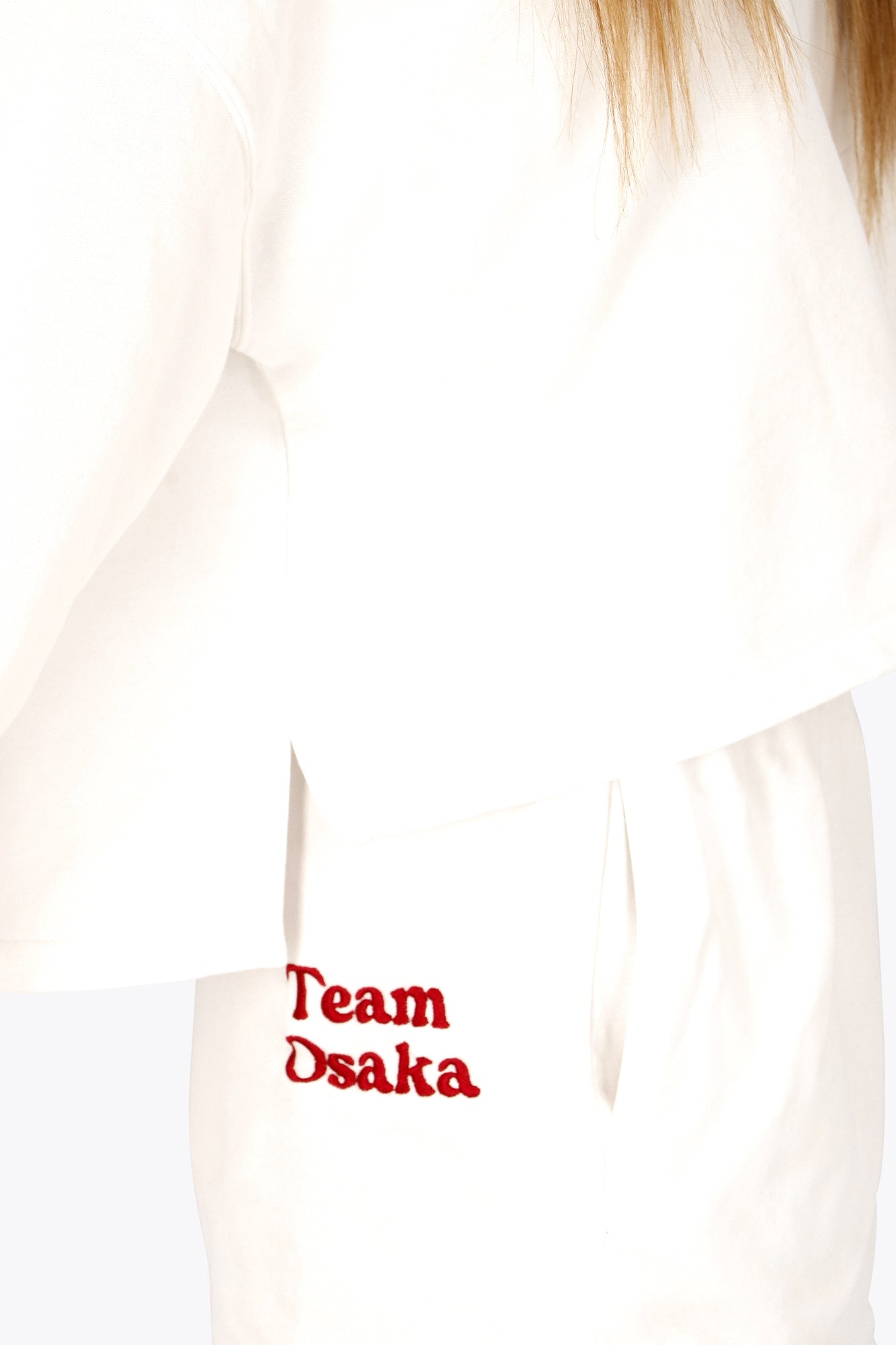 Osaka women cropped hoodie in white with logo in white. Side view