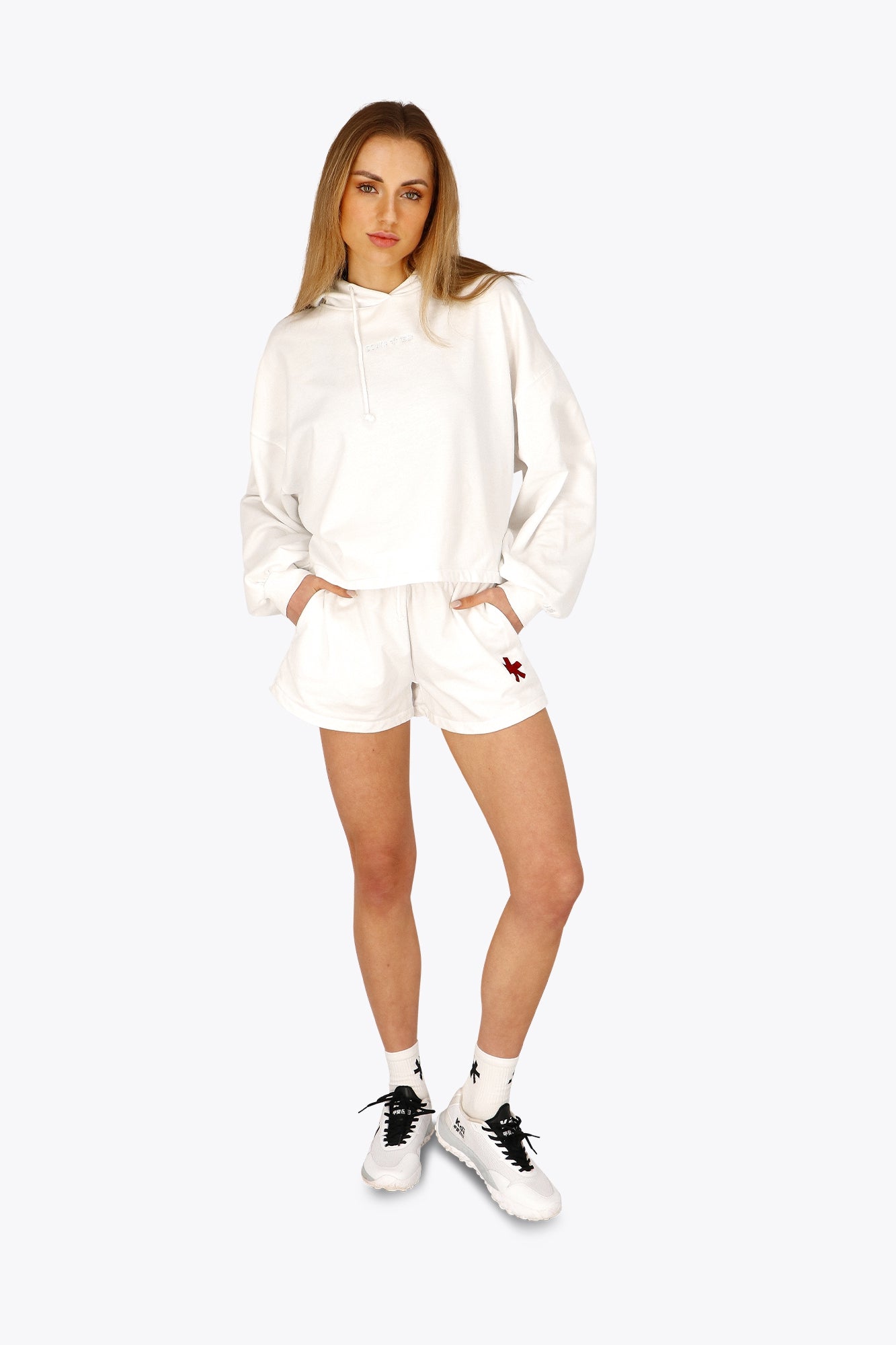 Woman wearing the Osaka women cropped hoodie in white with logo in white. Front view