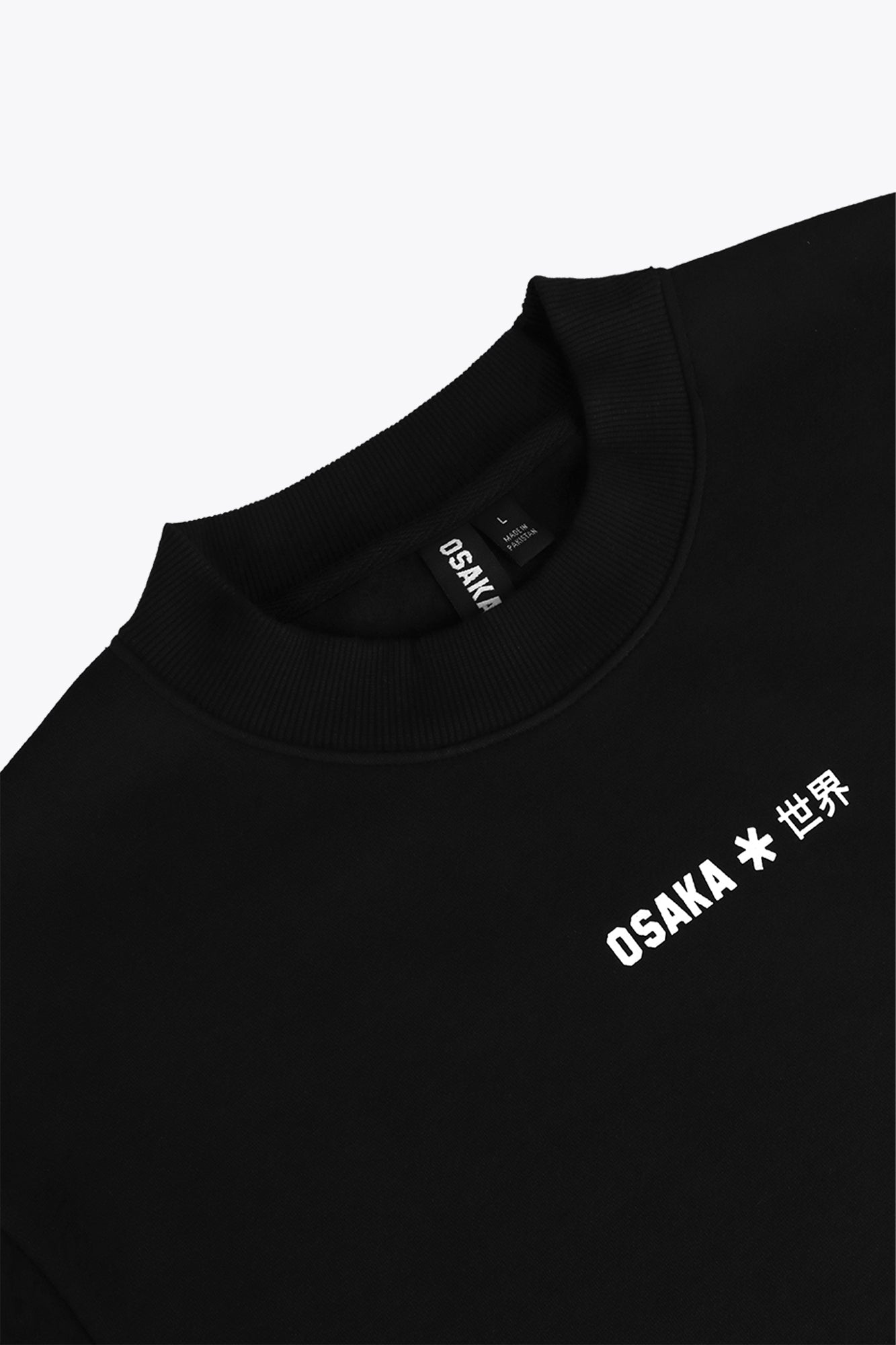 Osaka unisex sweater signature black with white logo. Front detail logo view