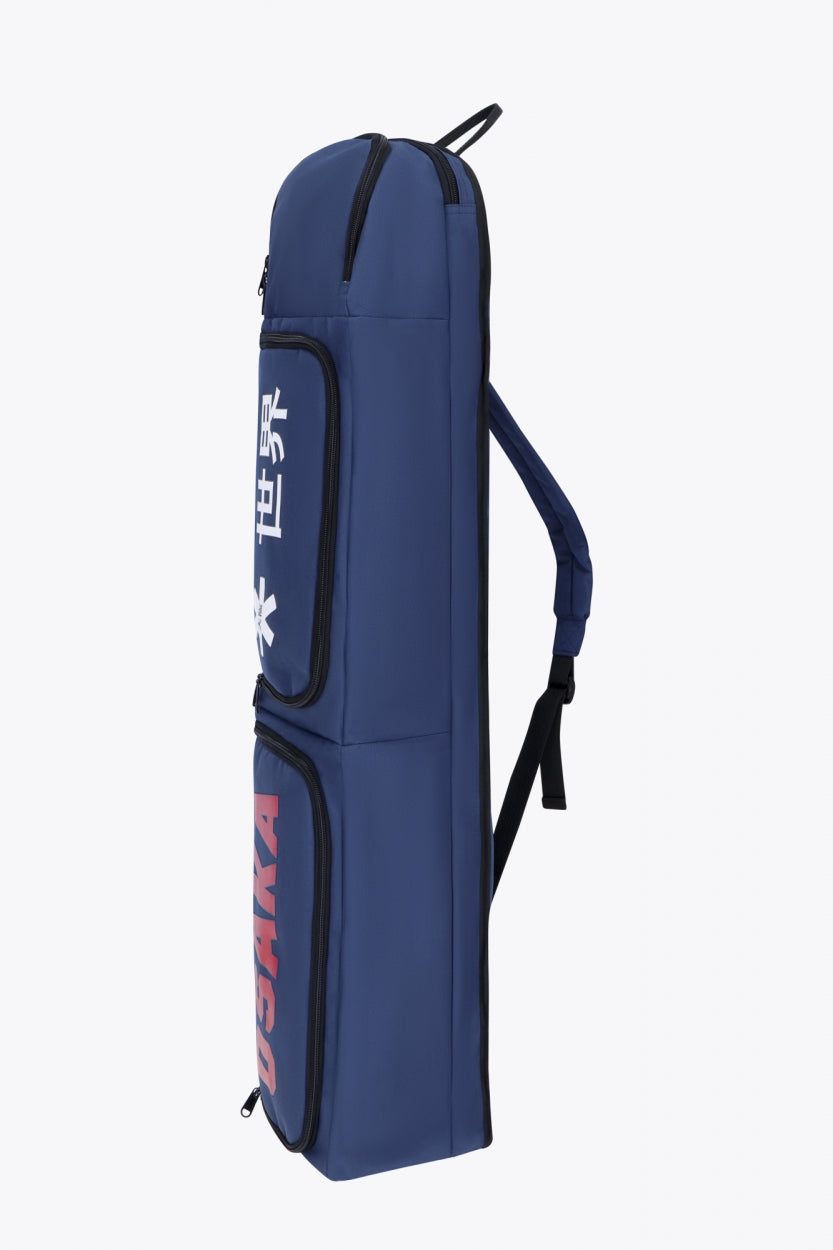 Osaka sports stickbag medium in navy with logo in white and red. Side view