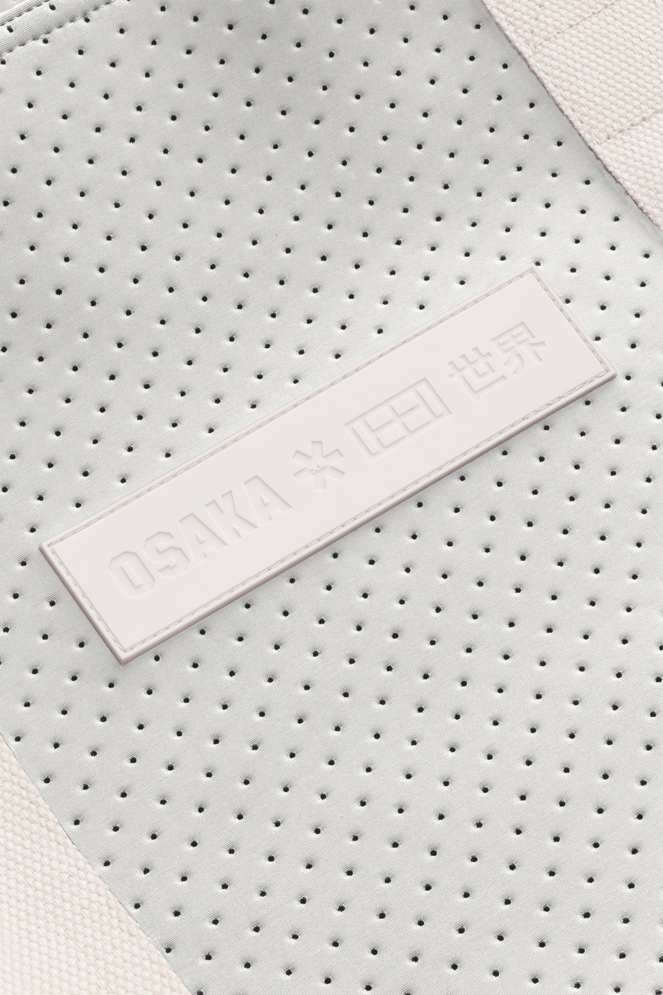 Osaka neoprene Tote bag in light grey with structure and logo in white. Detail logo view