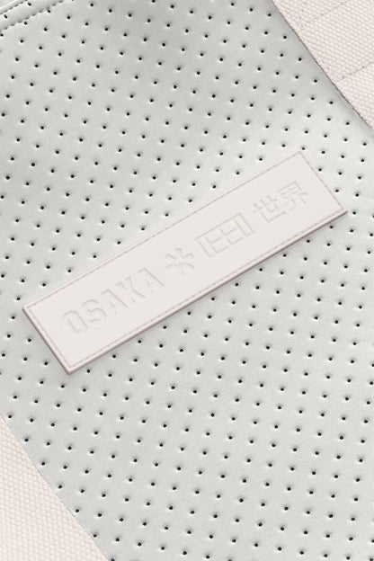 Osaka neoprene Tote bag in light grey with structure and logo in white. Detail logo view