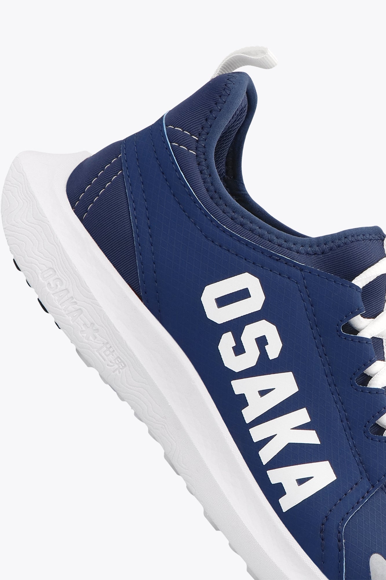 Osaka kids footwear in estate blue with logo in white. Detail logo view