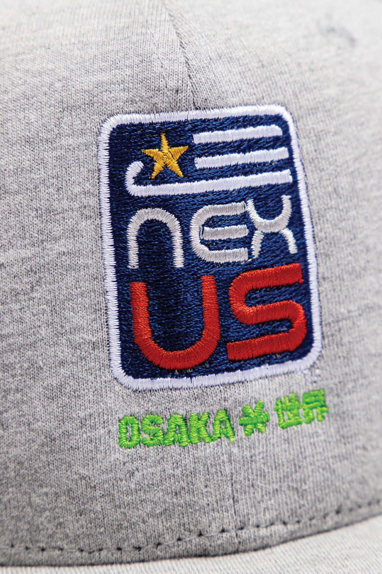 Osaka x Nexus cap in grey with Nexus logo in navy. Detail logo view