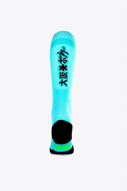 Osaka Field Hockey Socks in sky blue with Osaka logo in green. Back view