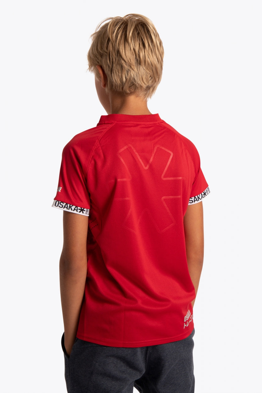 Boy wearing the Osaka Kids Jersey in Red. Back view